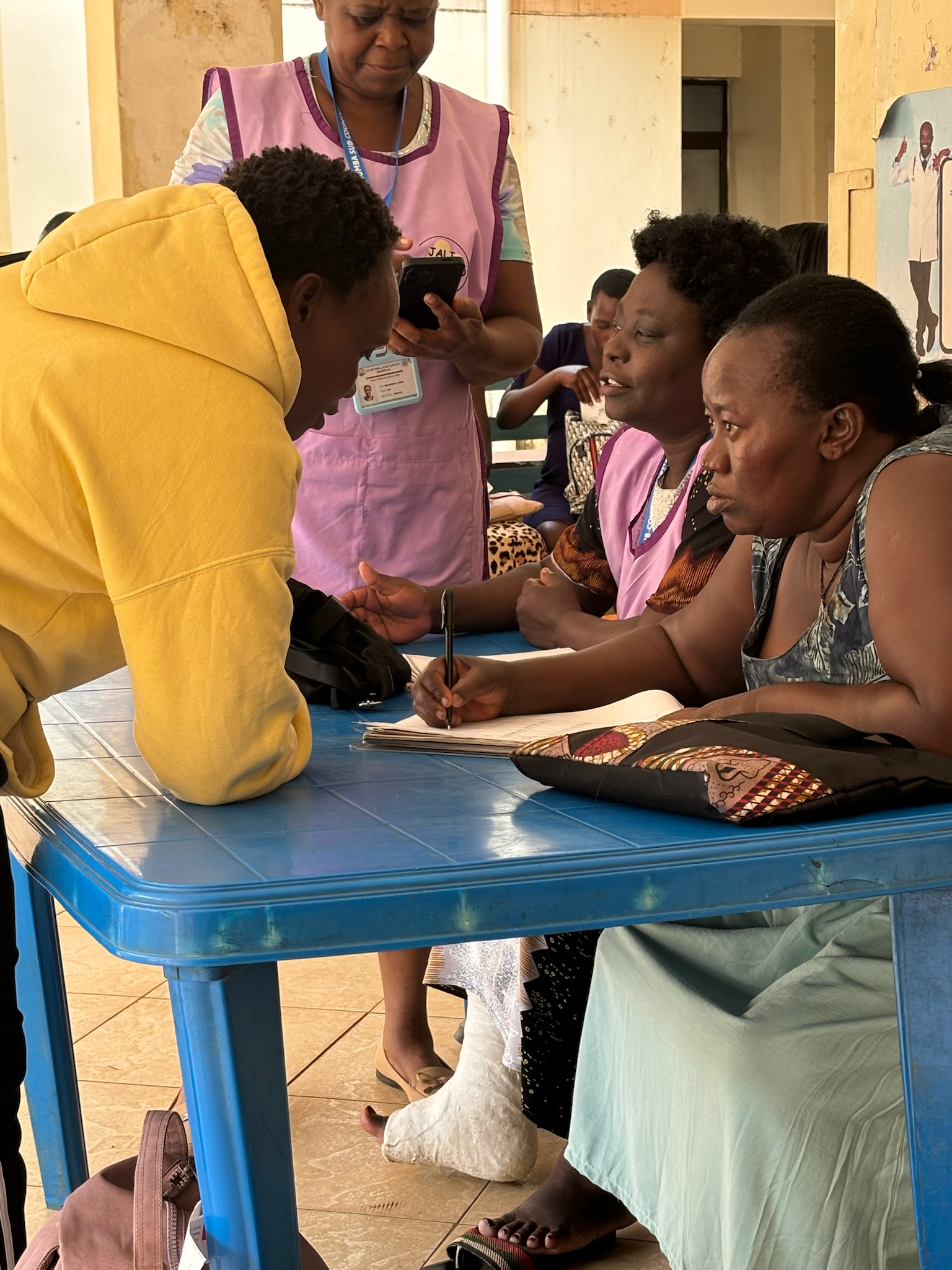 Staff assisting mothers at Jali Watoto